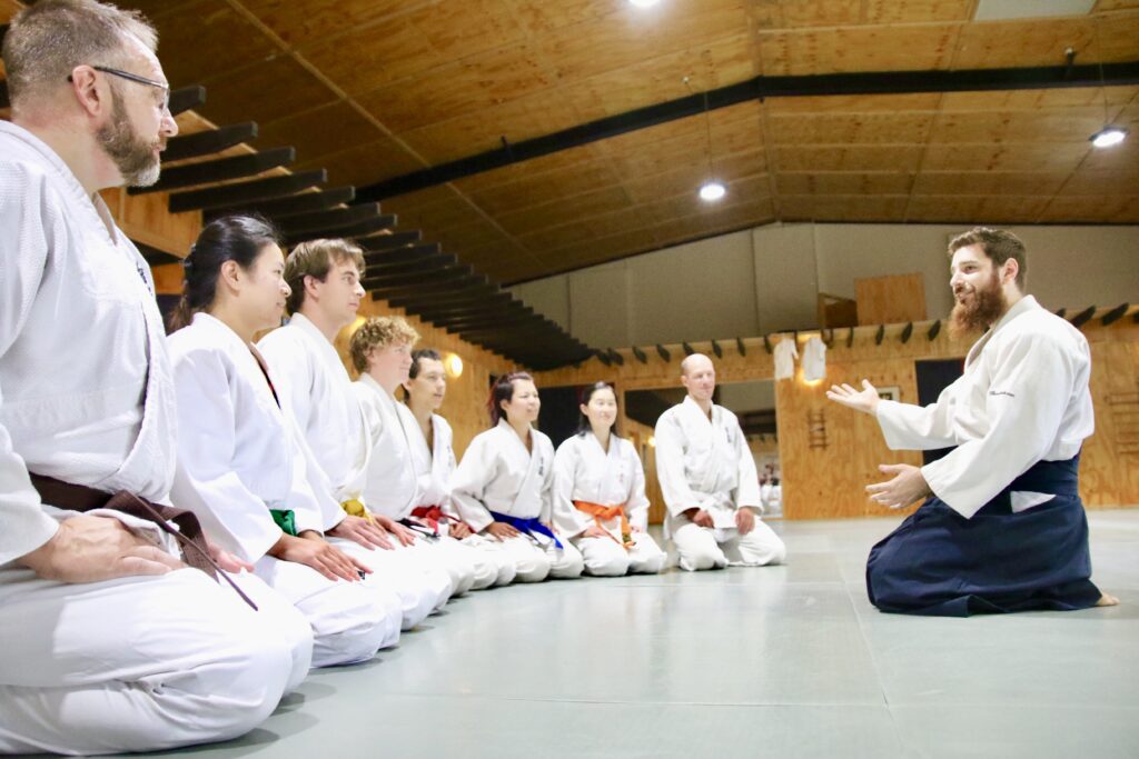 students learning aikido in a traditional setting