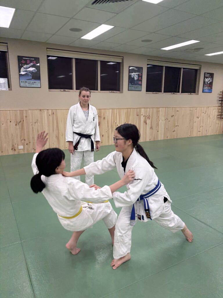 Advanced kids martial arts class practising Aikido techniques